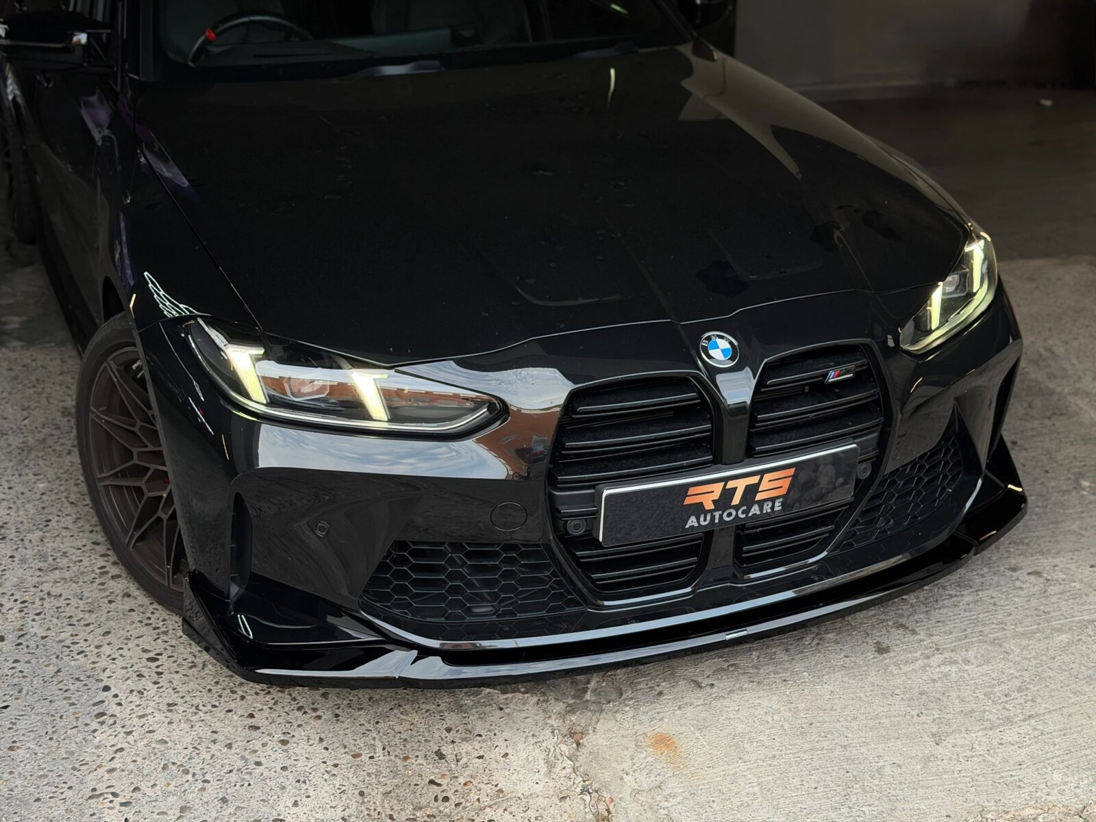 Front three-quarter view of a black BMW M4 Competition after work at RTS Autocare
