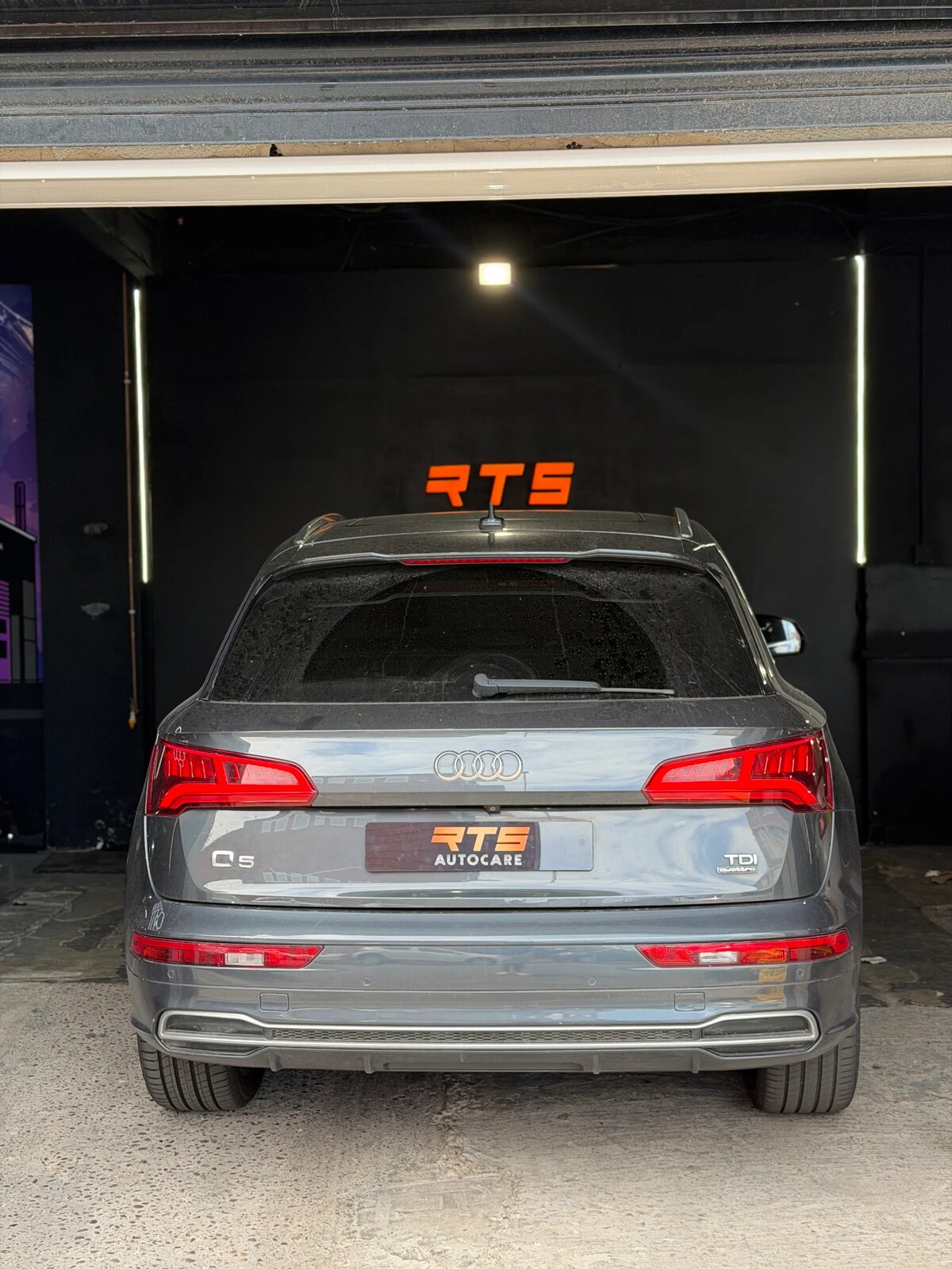 Audi Q5 TDI quattro parked under the illuminated RTS sign