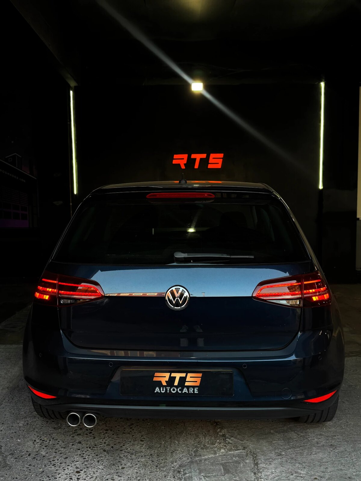 Volkswagen Golf with RTS Autocare plate in the workshop entrance