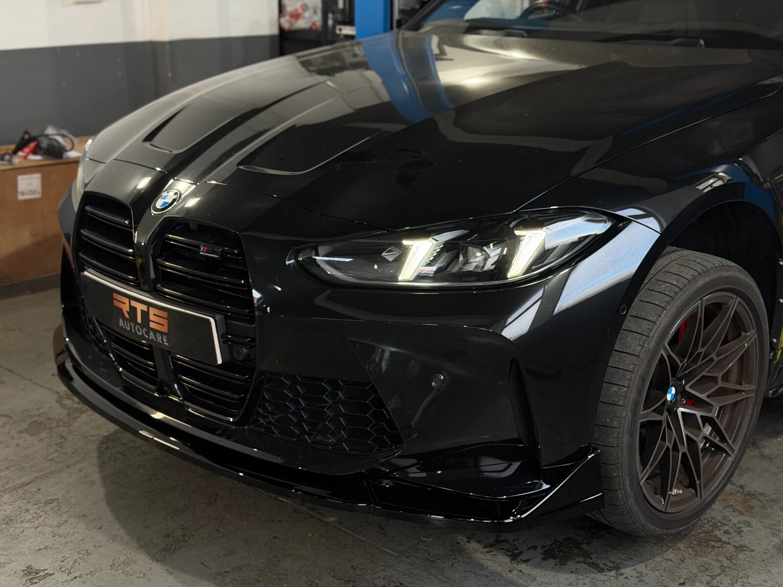Close-up of a BMW M4 Competition front splitter fitted at RTS Autocare