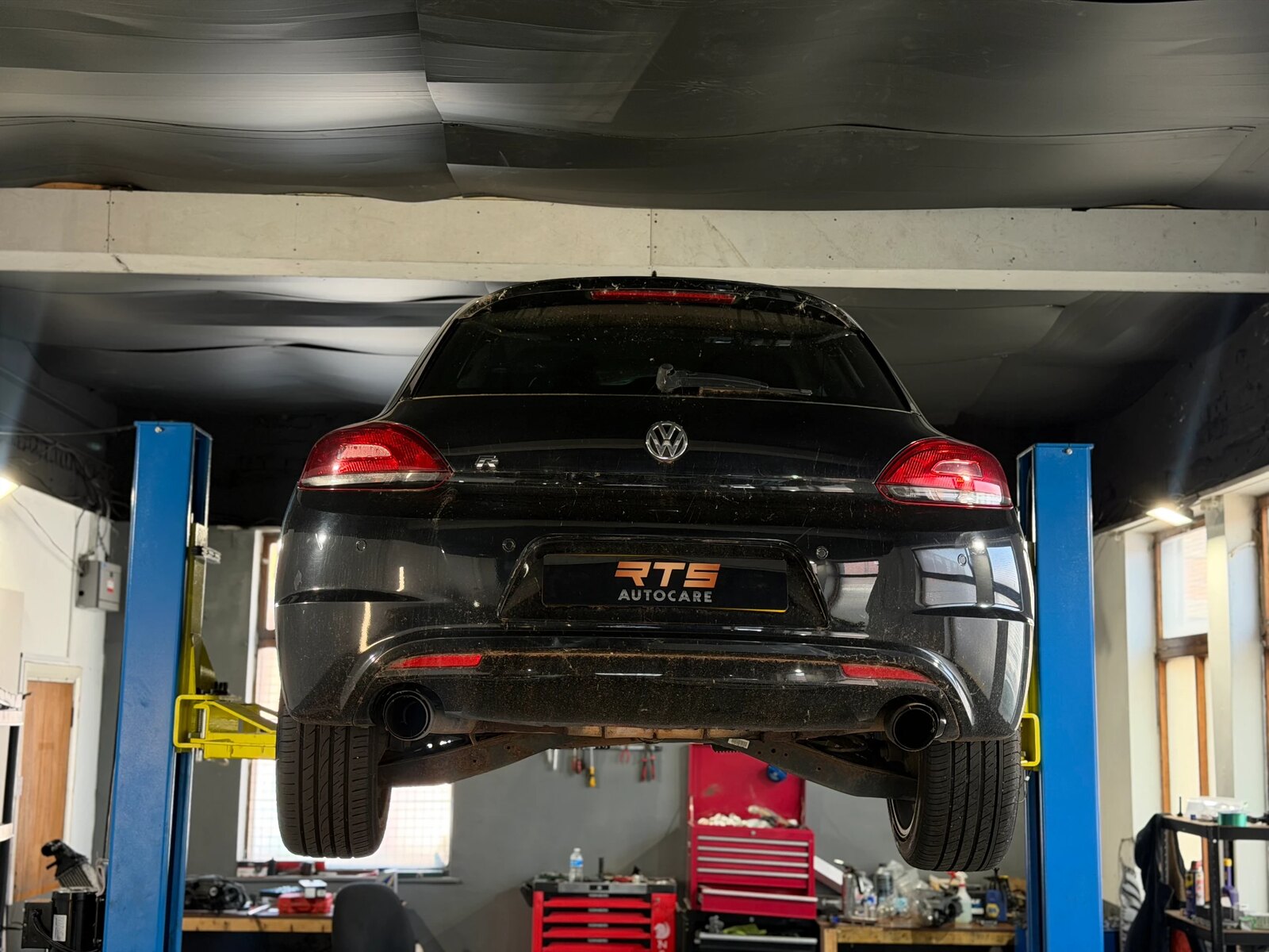 Volkswagen Scirocco R raised on the two-post ramp inside the RTS Autocare workshop